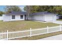 Lovely single-story home featuring a white picket fence, manicured lawn, and a charming facade at 1497 Jay St, Longwood, FL 32750