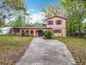 Charming two-story home with arched front entryway and concrete driveway at 15523 Old Cheney Hwy, Orlando, FL 32828