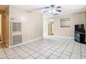 Spacious living room with tile flooring, ceiling fan, and neutral paint, providing a bright and airy feel at 15523 Old Cheney Hwy, Orlando, FL 32828