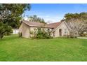 The front lawn is lush and spacious and includes mature trees at 1582 Darlington Ave, Deltona, FL 32725