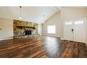 Sun-filled open-concept living room with vaulted ceilings and a stone fireplace at 1582 Darlington Ave, Deltona, FL 32725