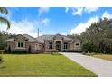 Well-maintained home with a tile roof, a neatly landscaped front yard, and a long driveway leading to the garage at 1726 Brackenhurst Pl, Lake Mary, FL 32746