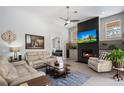 Comfortable living room with a stone fireplace, a ceiling fan, and plush seating for relaxing and entertaining at 1726 Brackenhurst Pl, Lake Mary, FL 32746