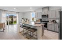 Open kitchen layout featuring a granite island with seating and stainless steel appliances at 2124 Monteverde, Davenport, FL 33896