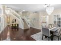 Elegant foyer with a grand staircase, chandelier, and hardwood floors at 235 Nob Hill Cir, Longwood, FL 32779