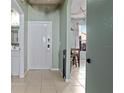 Bright foyer with tiled flooring, complemented by the modern finishes and an open view to the dining area at 2511 Calabria Ave, Davenport, FL 33897