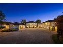 Elegant home with a circular driveway, a multi-car garage, and exterior illumination at 3120 Downs Cove Rd, Windermere, FL 34786