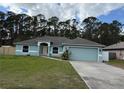 Charming single-story home featuring a well-manicured lawn and attached two-car garage, perfect for suburban living at 3200 Utah Dr, Deltona, FL 32738