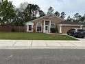 Well-maintained single-story home with lush green lawn and a symmetrical facade, creating a welcoming curb appeal at 3220 Town And Country Rd, Oviedo, FL 32766