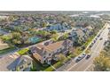 An aerial view of a residential neighborhood featuring well-maintained townhouses and community pool at 4038 Hunters Park Ln, Orlando, FL 32837