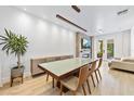 Bright dining room featuring a modern table, light fixture, fireplace, and sliding glass doors to backyard at 4038 Hunters Park Ln, Orlando, FL 32837