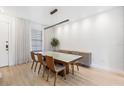 Bright dining room featuring modern chandelier, large windows, and contemporary furniture at 4038 Hunters Park Ln, Orlando, FL 32837