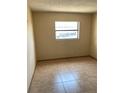 A bedroom with a tile floor and a window for natural light at 4206 Clarinda St, Orlando, FL 32811