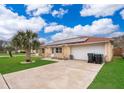 Well-maintained single-story home features solar panels, a two-car garage, and a meticulously landscaped front yard at 4303 Tomlinson Cir, Orlando, FL 32829