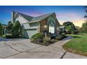 This home features brick and vinyl siding, with an attached garage and landscaped front at 4537 Woodlands Village Dr, Orlando, FL 32835