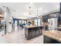 Spacious kitchen island with granite countertops, stainless steel appliances, and dark cabinetry at 4622 Fairy Tale Cir, Kissimmee, FL 34746