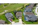 Aerial view of a home situated near a golf course, boasting a private pool and a two-car garage at 523 Higher Combe Dr, Davenport, FL 33897