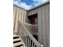 Close-up of a two-story entrance with wooden stairs leading to the unit at 5316 Burning Tree Dr # A-09-2, Orlando, FL 32811