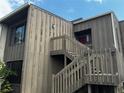 Exterior view of a two-story building with wooden stairs leading to the entrance at 5316 Burning Tree Dr # A-09-2, Orlando, FL 32811