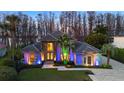 Beautiful two-story home with colored landscape lighting enhancing its curb appeal at 5524 Sail Ct, Orlando, FL 32819