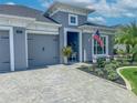 Charming home with a two-car garage, landscaped yard, and a welcoming front porch at 585 Mosaic Blvd, Daytona Beach, FL 32124