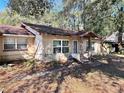 Charming single-story home with a covered front entry and mature shade trees in the front yard at 7002 Rose Ave, Orlando, FL 32810