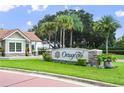 Entrance to the Orange Tree community with lush landscaping and an inviting gatehouse at 7037 Edgeworth Dr, Orlando, FL 32819