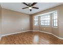 Serene bedroom with natural light from bay window, featuring neutral tones and wood floors at 7215 Scenic Pl, Lakeland, FL 33810