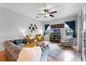 Comfortable living room featuring a ceiling fan, plush seating, and abundant natural light at 739 Spring Island Way, Orlando, FL 32828