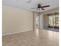 Living room featuring tile floors, ceiling fan, and a sliding glass door with lanai access at 8323 Bella Vida Cir, Davenport, FL 33896