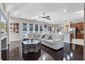 Bright and airy living room with hardwood floors, a white sectional, and large windows for natural light at 8712 Irmastone Way, Orlando, FL 32817