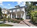 Beautiful two-story home with brick driveway and detached garage, blending style and functionality at 909 E Central Blvd, Orlando, FL 32801