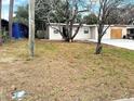 Inviting single-story home featuring a cozy front yard with mature trees and a driveway at 913 Ferndell Rd, Orlando, FL 32808