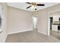 Neutral living room with tile floors, a ceiling fan, and seamless access to the updated kitchen at 913 Ferndell Rd, Orlando, FL 32808