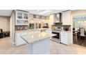 Bright kitchen featuring an island, stainless steel appliances, granite countertops, and decorative backsplash at 922 Puma Trl, Winter Springs, FL 32708