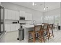 Well-lit kitchen with white cabinetry, modern appliances, an island, and seating at 9235 San Jose Blvd, Howey In The Hills, FL 34737