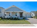 Beautiful single-story home boasts a covered front porch and a convenient two-car garage at 9834 Introduction Way, Orlando, FL 32832