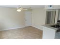 Neutral living area featuring tile flooring, a ceiling fan, and a front door at 1029 S Hiawassee Rd # 2414, Orlando, FL 32835
