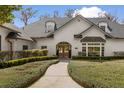 Grand entrance featuring arched doorways and manicured landscaping, creating an inviting approach at 1404 Kelso Blvd, Windermere, FL 34786