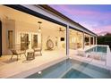 Covered outdoor living space with pool, seating, ceiling fans, and seamless access to the home's interior at 1404 Kelso Blvd, Windermere, FL 34786