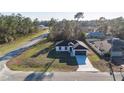Aerial view of a single-story home with mature landscaping and a paved driveway at 16224 Sw 55Th Court Rd, Ocala, FL 34473