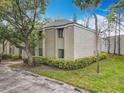 Building exterior view featuring lush greenery, landscaping, and clear blue skies at 163 Springwood Cir # D, Longwood, FL 32750