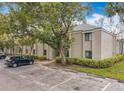 Condo building exterior showcasing parking, mature trees, and tidy green landscaping at 163 Springwood Cir # D, Longwood, FL 32750
