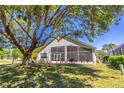 The home's backyard features a screened-in lanai providing an ideal space for outdoor relaxation at 1714 Golfview Dr, Kissimmee, FL 34746
