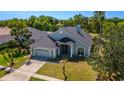 Charming single Gathering home with well-kept lawn, lush landscaping, and a two-car garage at 1714 Golfview Dr, Kissimmee, FL 34746