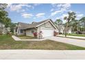 Charming single-story home features a two-car garage, well-manicured lawn, and mature landscaping at 2007 Cornell Pl # 4, Port Orange, FL 32128