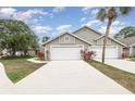 Charming townhomes feature two-car garages, ample parking, and colorful landscaping at 2007 Cornell Pl # 4, Port Orange, FL 32128