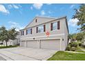 Neutral siding, brown shutters, and well-maintained landscaping enhance this three car garage townhome at 3528 Seneca Club Loop # 103 - C, Orlando, FL 32808