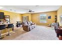 Open-concept living room with carpeted floor, ceiling fan, and casual dining area at 3528 Seneca Club Loop # 103 - C, Orlando, FL 32808