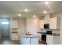 Stylish kitchen with granite countertops, stainless steel appliances, and an island with sink at 3641 Marlberry Way, Sanford, FL 32773